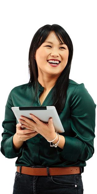 A woman in a green shirt holding a tablet and smiling.